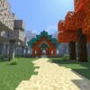 A path running between a pale gray forest and an orange autumn forest toward a building made of copper and oxidized copper blocks